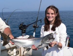 charter fishing girl holds her fish