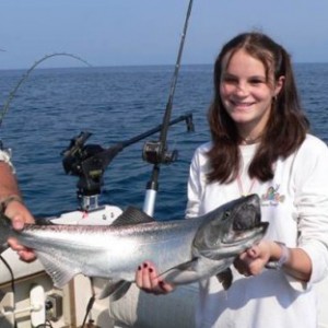 charter fishing girl holds her fish