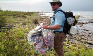 picking up trash on the shore
