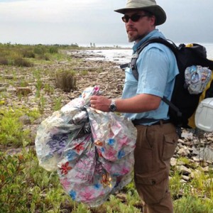 picking up trash on the shore