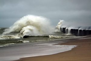 waves crashing into pier