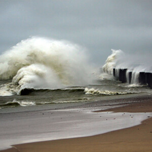 waves crashing into pier