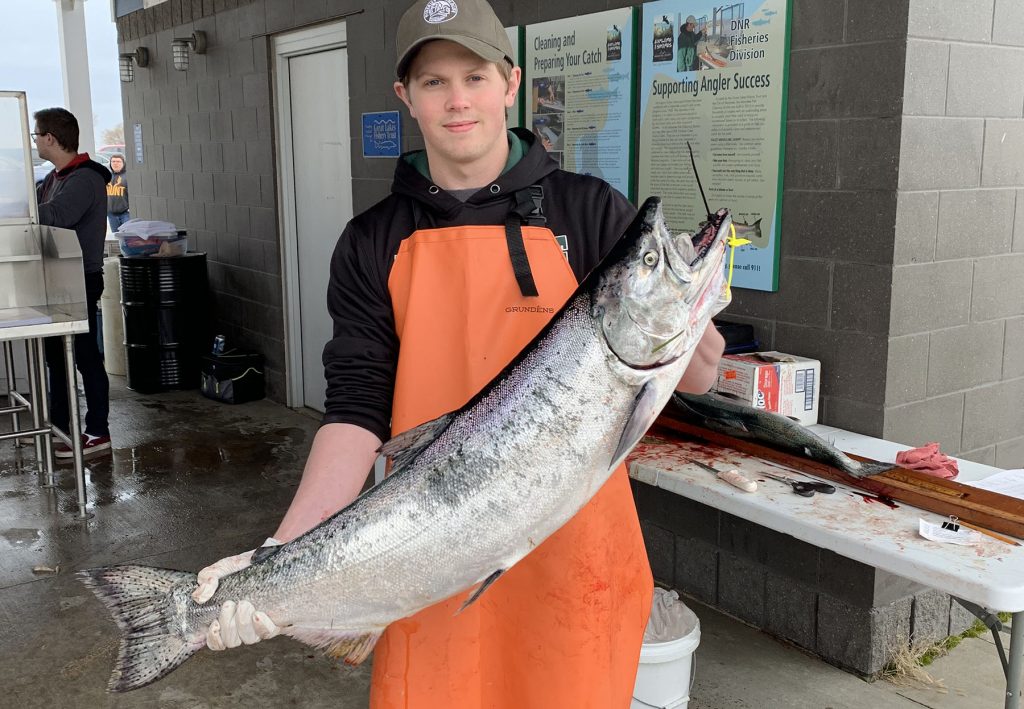 Field tec holding a chinook salmon