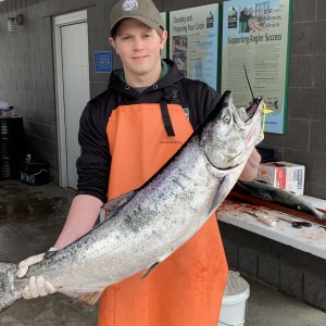 Field tec holding a chinook salmon