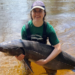 researcher holding a lake sturgeon caught during sampling