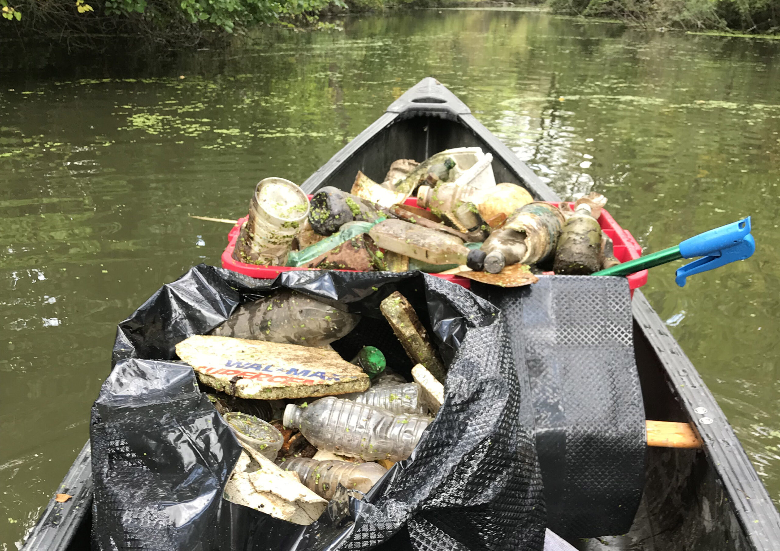 Ecorse River Clean Up looking at garbage collection from a canoe