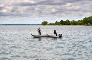2 people on a fishing boat on a lake