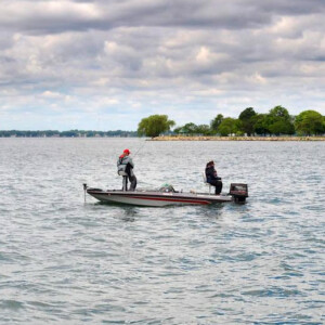 2 people on a fishing boat on a lake