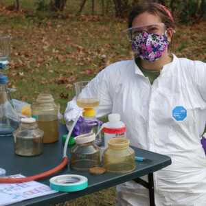 A researcher sampling septic fields with equipment