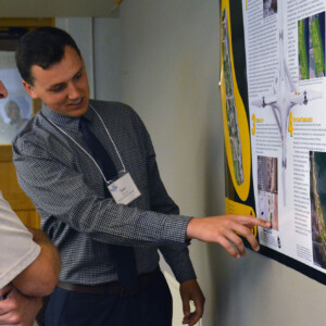 Tom at a student internship poster presentation