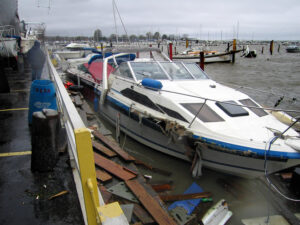 A Marina with a damaged boat surrounded by debris from Superstorm Sandy