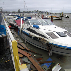 A Marina with a damaged boat surrounded by debris from Superstorm Sandy
