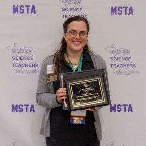 Meaghan Gass holds her award plaque