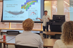 Abe presents to an audience about the Keweenaw Forest project
