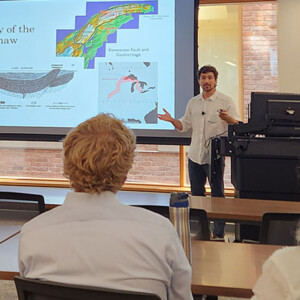 Abe presents to an audience about the Keweenaw Forest project