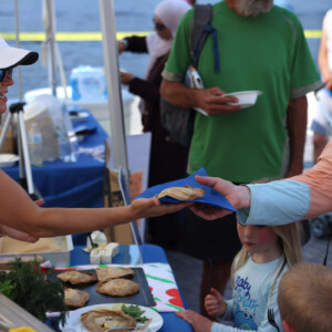 Visitors receive a fish pasty from a tasting demonstration at the fish fry. Photo: Monte Consulting