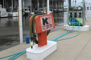 A older marina pumpout unit at a dock.