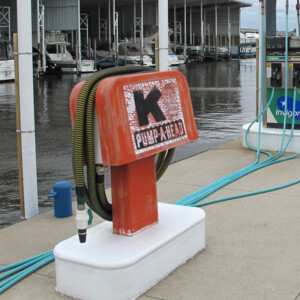 A older marina pumpout unit at a dock.