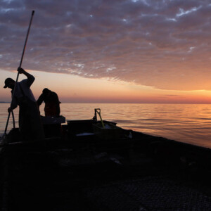 VanLandschoot & Sons Commercial Fishing on Lake Superior with a dramatic dark cloud sunset