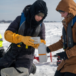 Researchers collect water samples from underneath the ice of Lake St. Clair