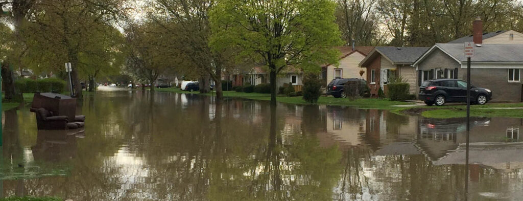 A flooded street in a coastal neighborhood.