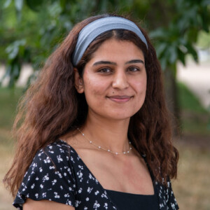 A close-up of Shehnaz, a young woman with dark hair and brown eyes