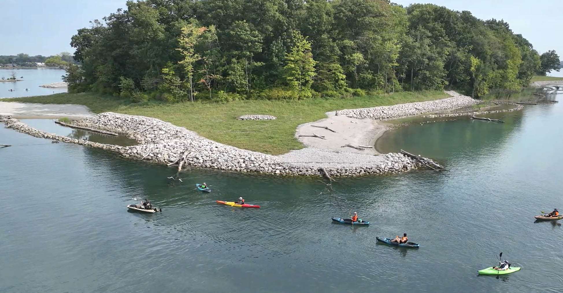 view of an island in a river with paddlers