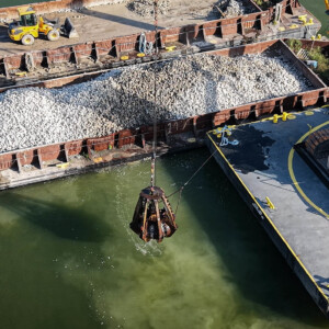 Machinery on a barge dropping substrate into the Lake to build a fish spawning reef.