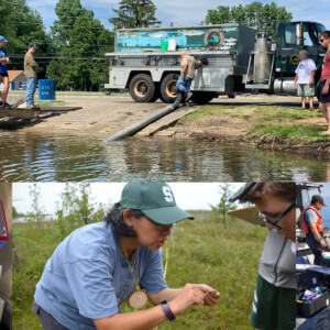 A group of students observing a fish stock release from a DNR truck