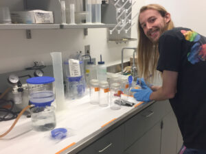A scientist in a lab working on a study with lab equipment on a table