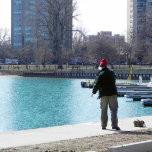 A person fishing near docks in Chicago