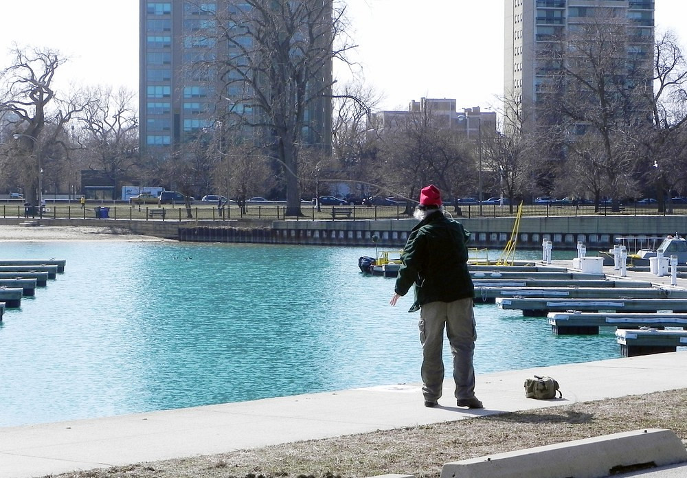 A person fishing near docks in Chicago