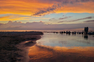 A dramatic sunset over a Lake with a river running out to the lake