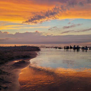 A dramatic sunset over a Lake with a river running out to the lake