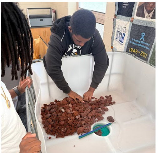 A student sorts through their aquaculture project