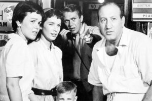 A group of four people from a black and white classic movie looking concerned