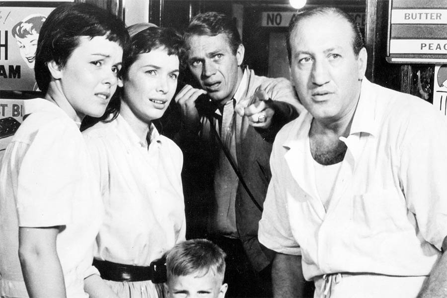 A group of four people from a black and white classic movie looking concerned